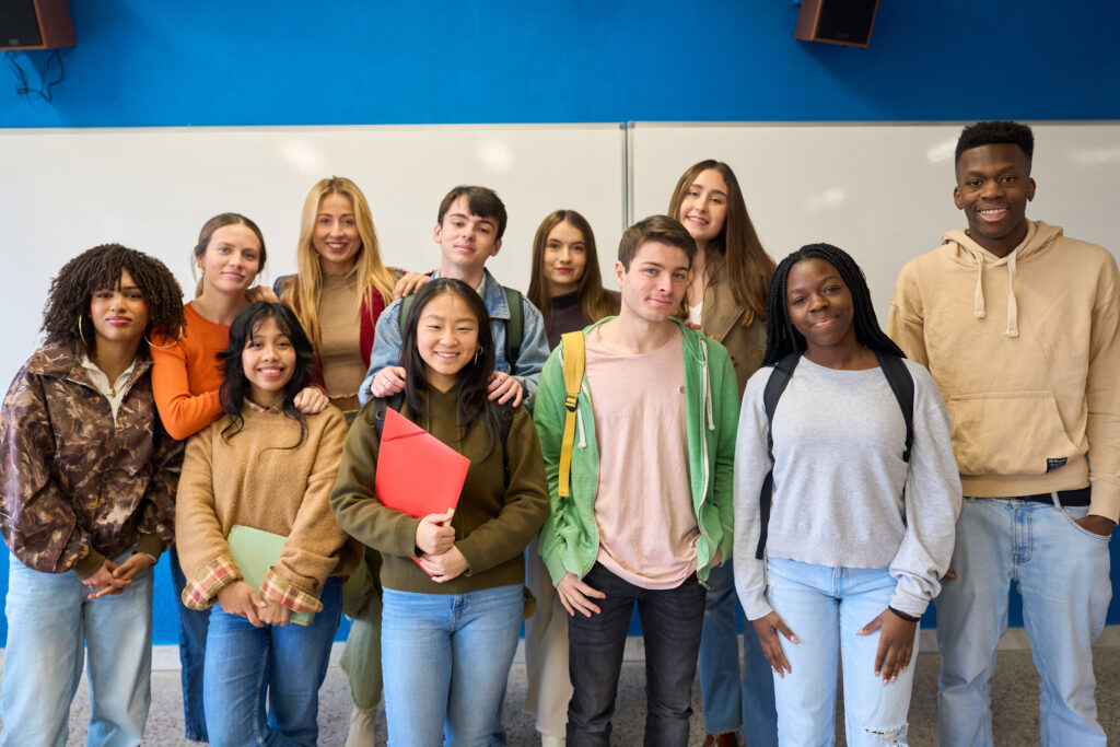 diverse group of institute students posing together in classroom